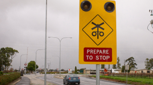 A 'prepare to stop' sign before a level crossing